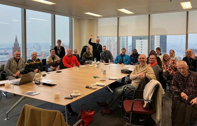 A group of people sitting around a table

Description automatically generated